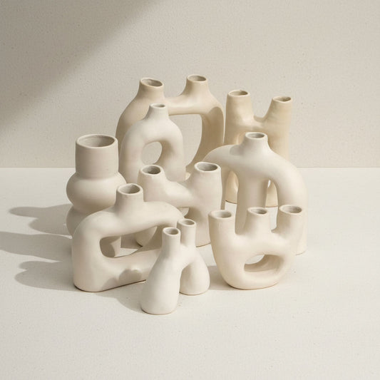 Group of handmade sculptural ceramic vases from Guadalajara, featuring organic minimal forms in matte white clay.