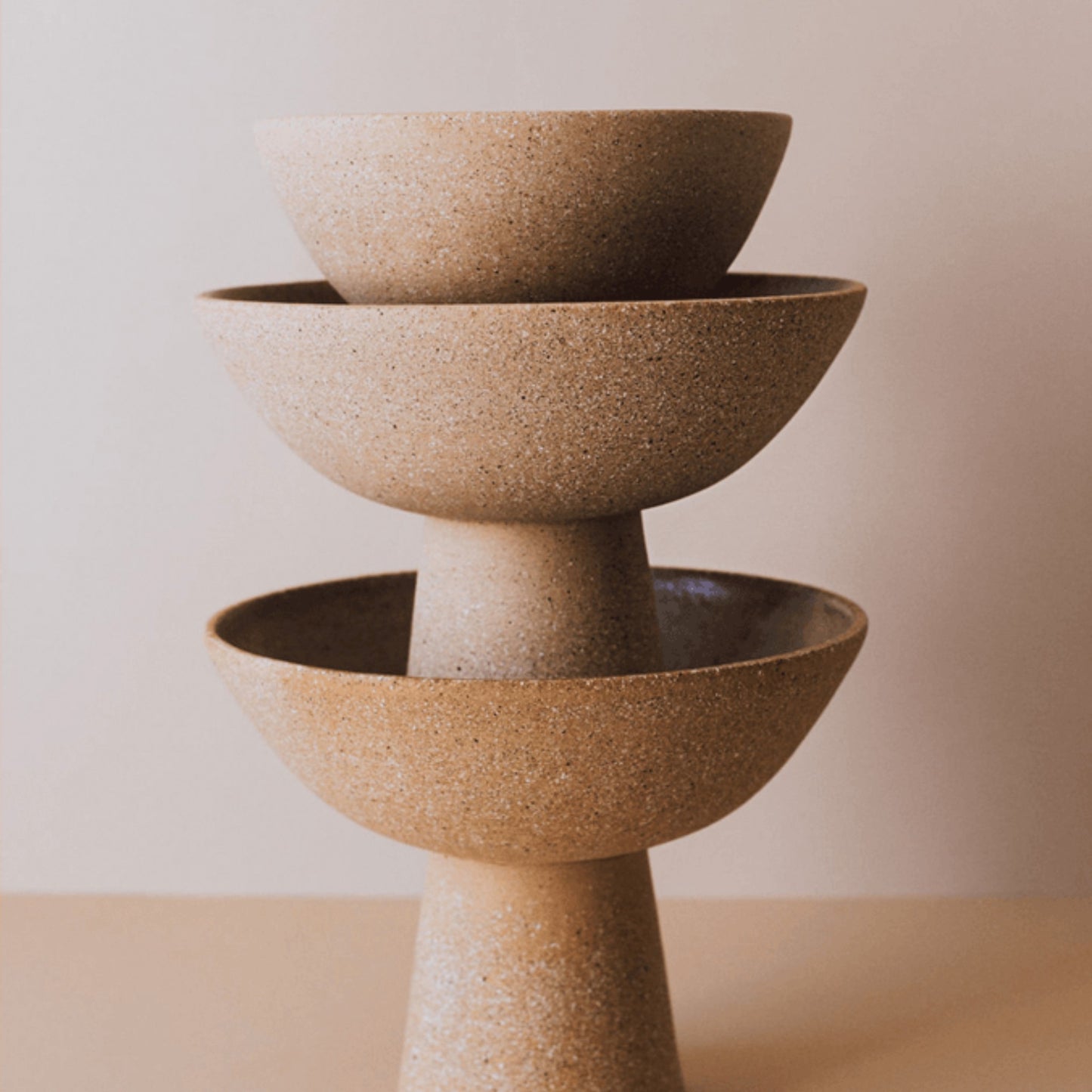 Stacked terracotta pedestal bowls showing tall and short centerpiece size options