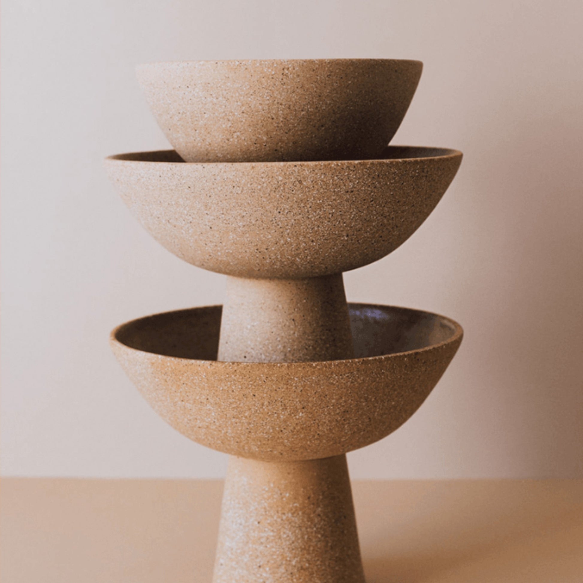Stacked terracotta pedestal bowls showing tall and short centerpiece size options