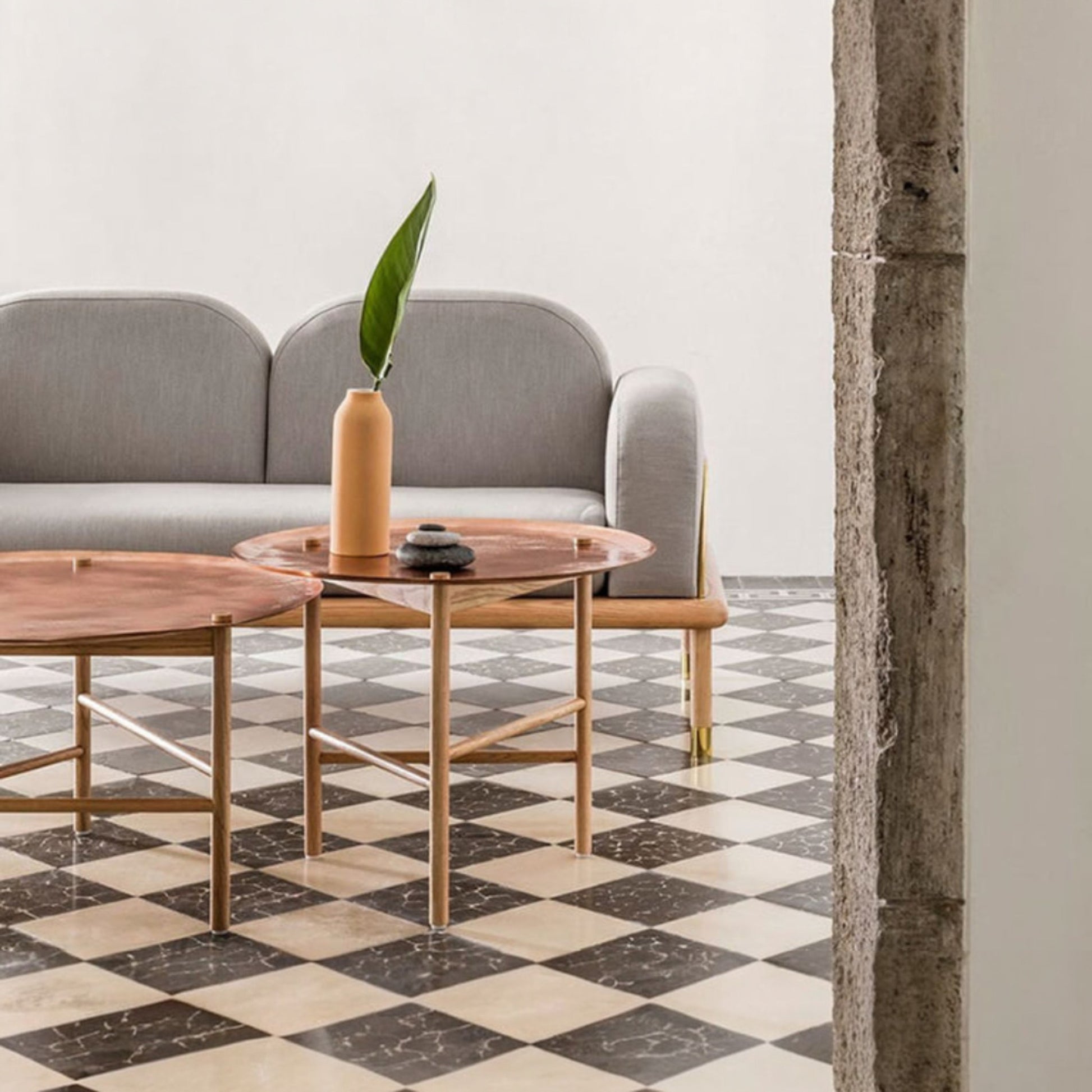 Terracotta urn vase styled in a warm living room with patterned floor tiles and neutral décor.