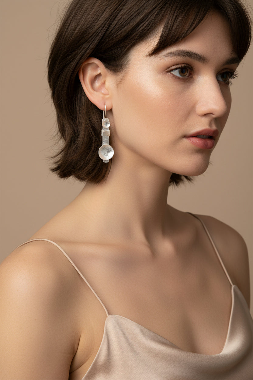 Model wearing gold plated disc drop earrings, side profile close-up