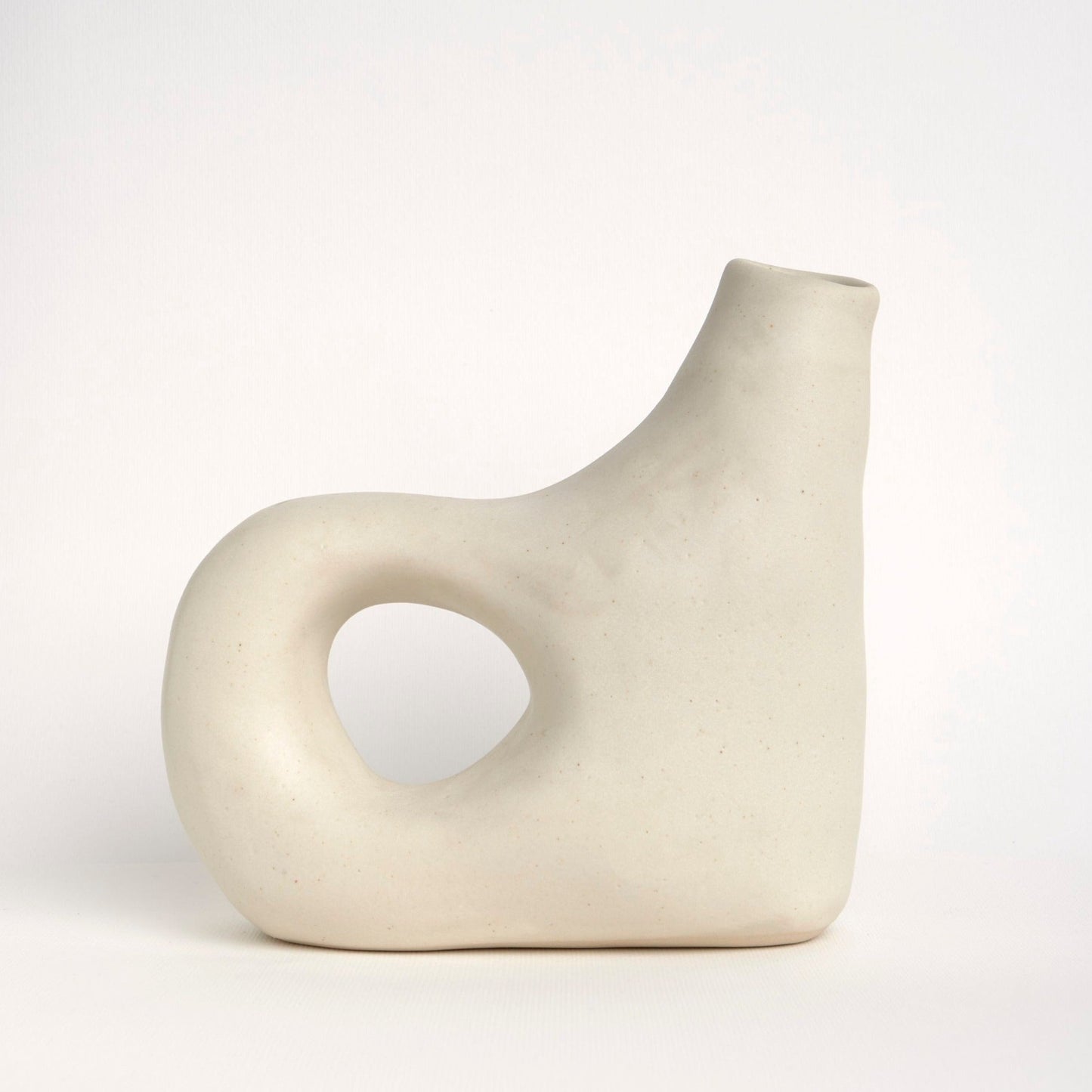 Close-up of curved spout ceramic vase 