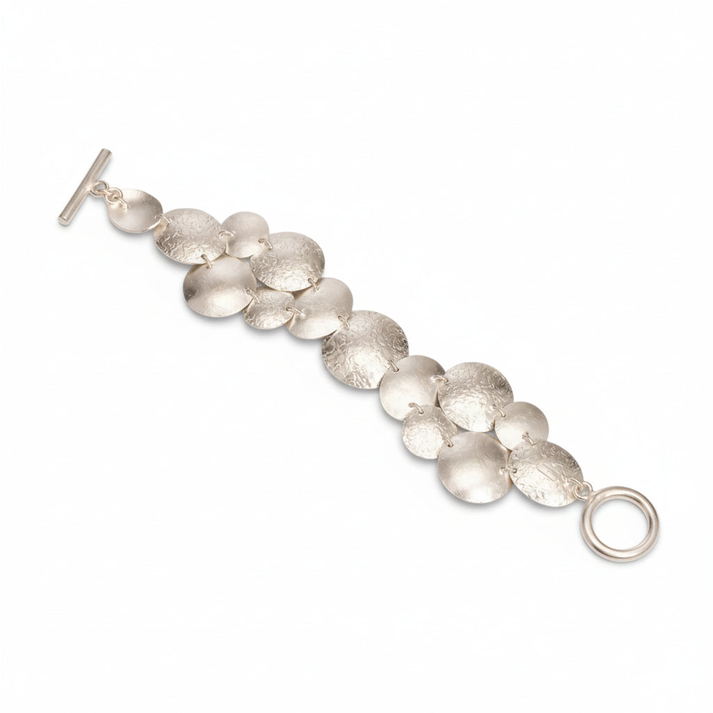 Handcrafted disc bracelet in silver plated bronze, hammered satin finish, artisan Mexican design