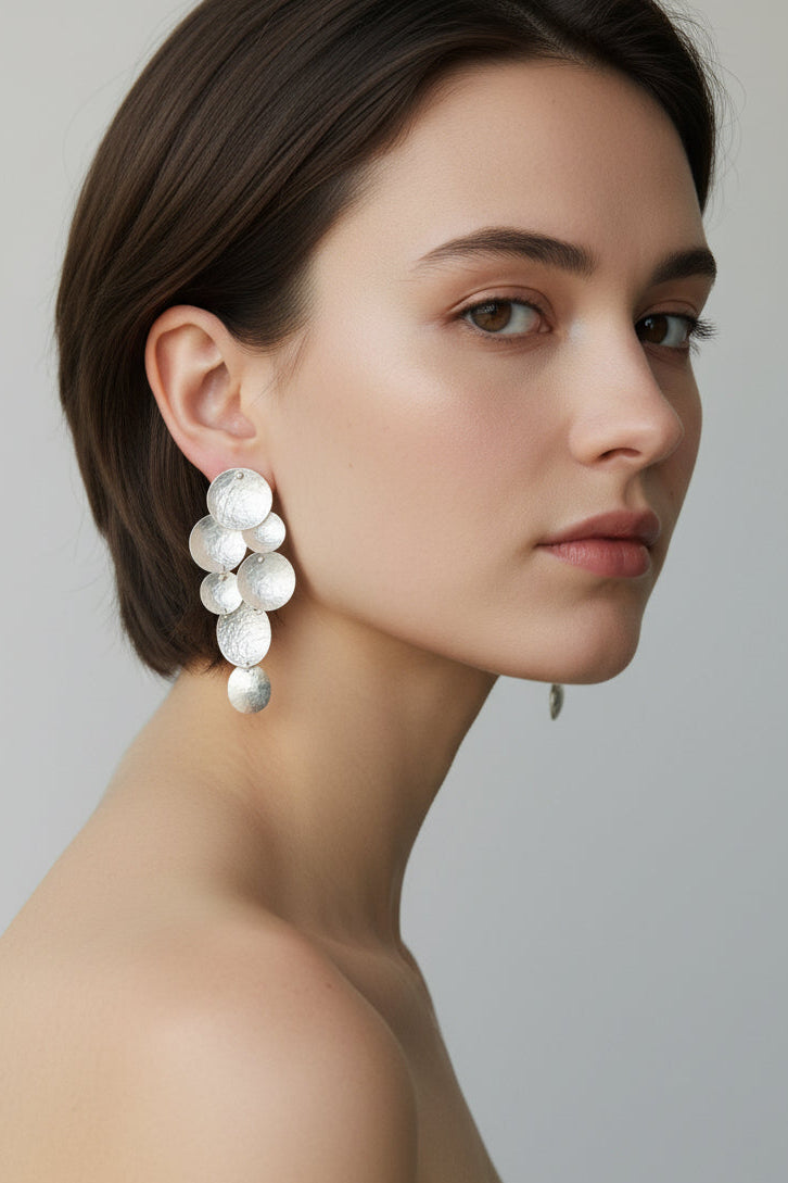 Cascade Sphere Earrings in sterling silver, sculptural cascading hammered spheres, worn on model, close-up