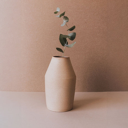 Handmade conical sand ceramic vase with eucalyptus stem, minimalist sculptural pottery from Mexico