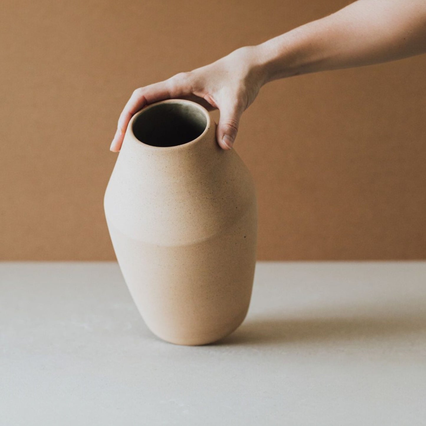 Sculptural conical ceramic vase in neutral sand color, artisan pottery from Mexico