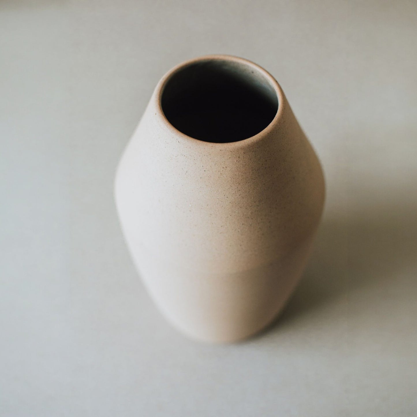 Top view of conical sand ceramic vase with glazed interior, handmade minimalist pottery
