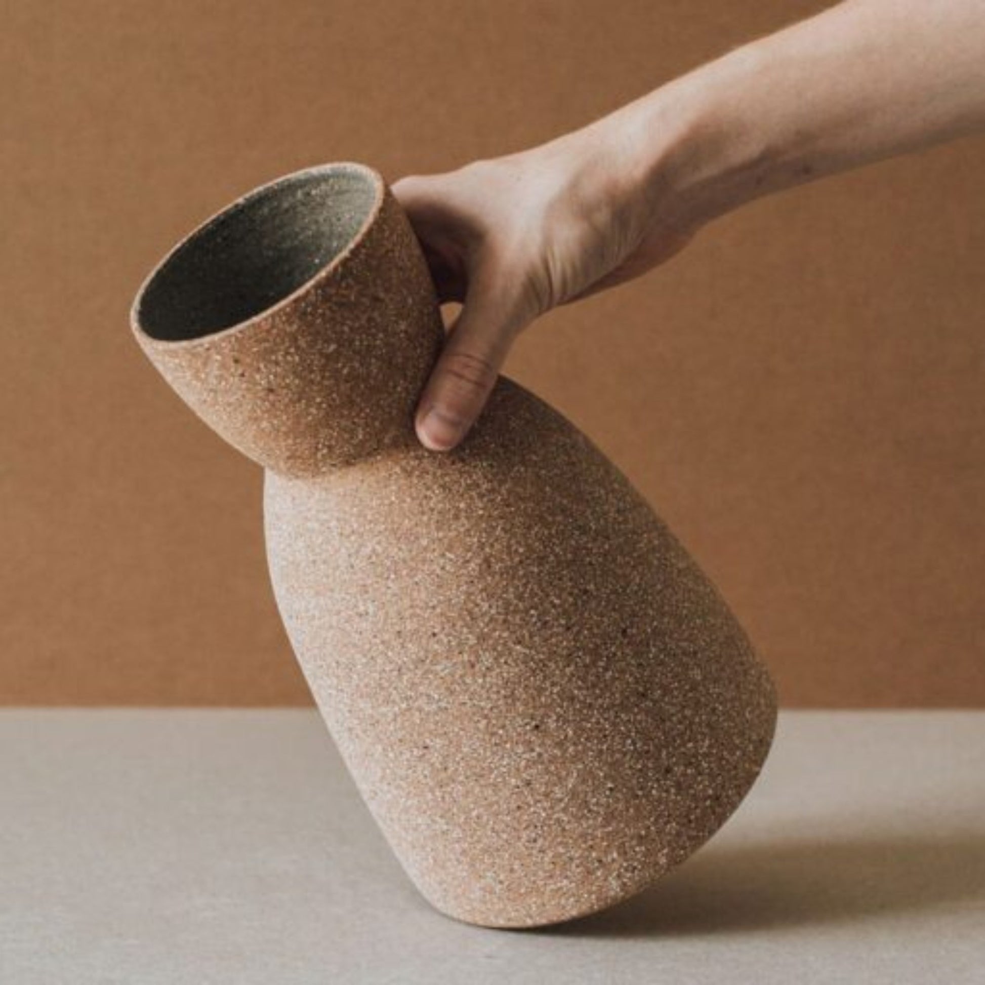 Artisan ceramic cork clock vase showing sculptural form and rustic matte finish