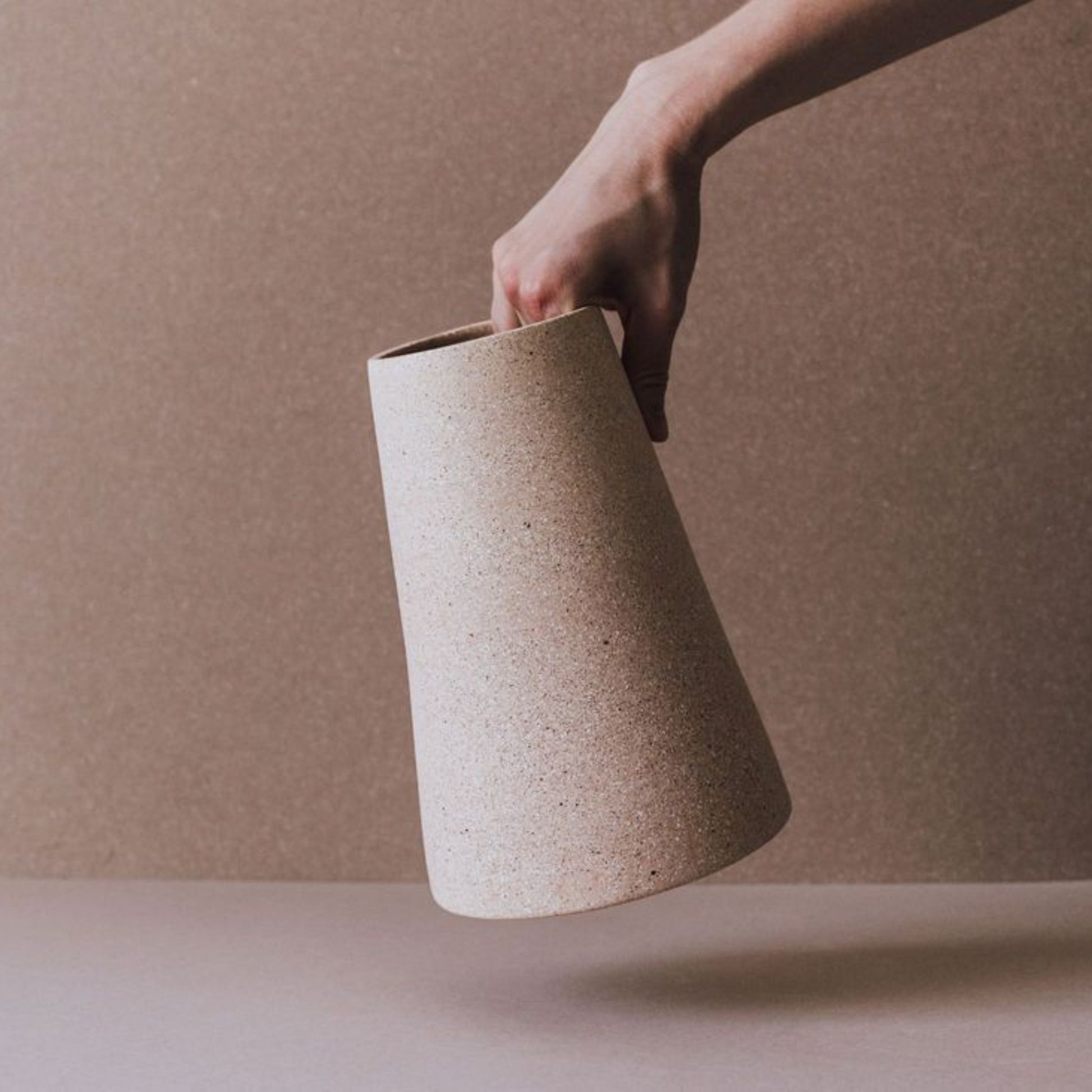 Artisan terracotta cone vase with tapered silhouette and matte rustic finish