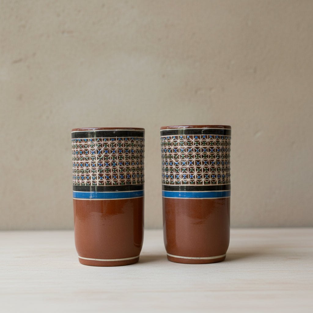 Two hand-painted Tonalá petatillo ceramic tumblers side by side