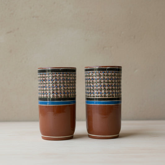 Two hand-painted Tonalá petatillo ceramic tumblers side by side