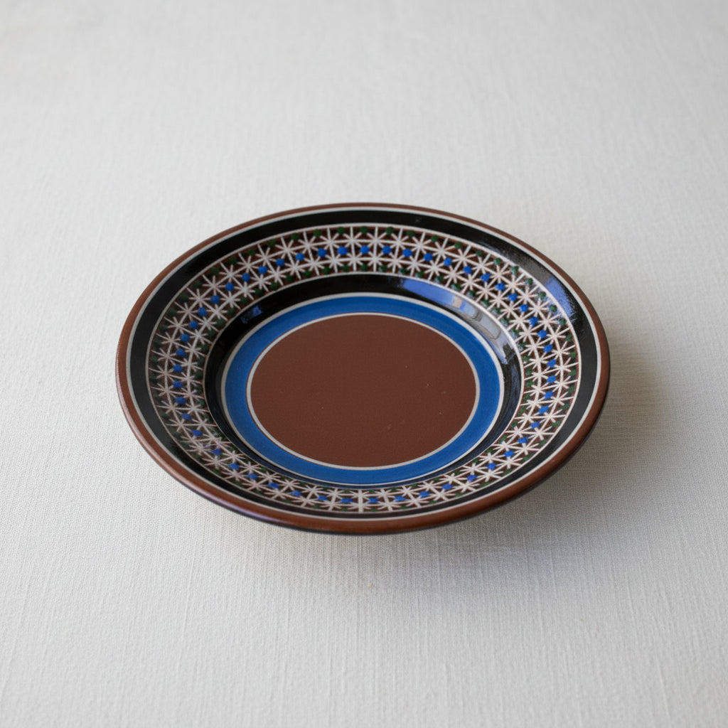 Top view of hand-painted Tonalá ceramic saucer with traditional petatillo pattern