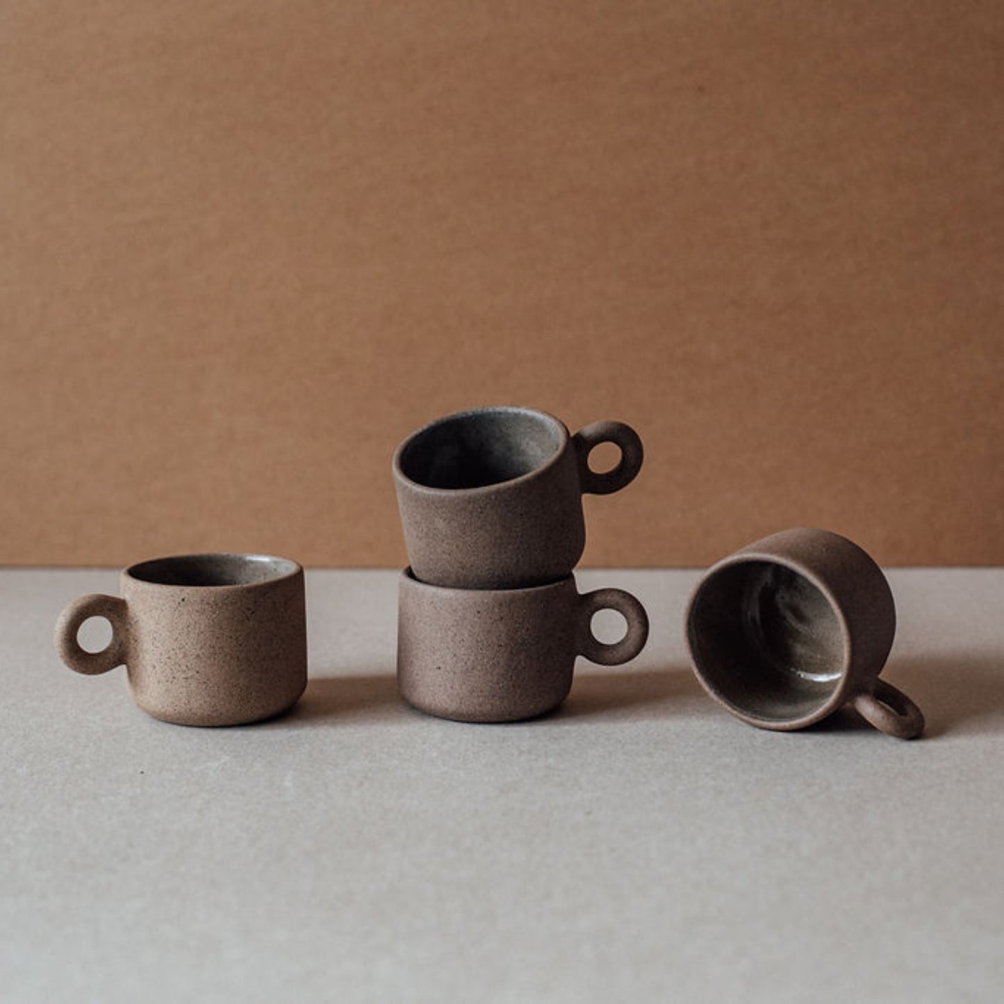 Set of handmade terracotta coffee cups with matte finish and minimalist design