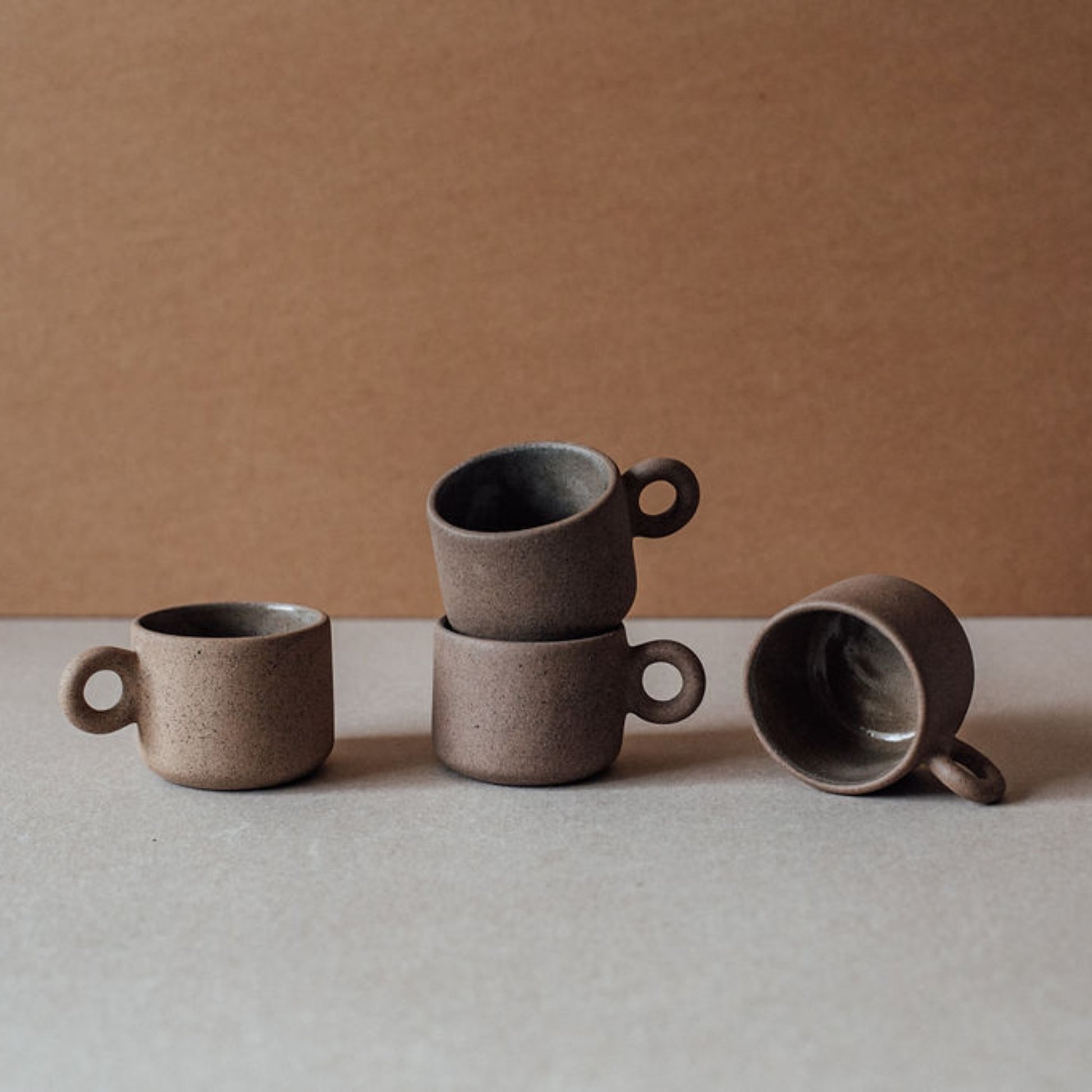 Set of handmade terracotta coffee cups with matte finish and minimalist design