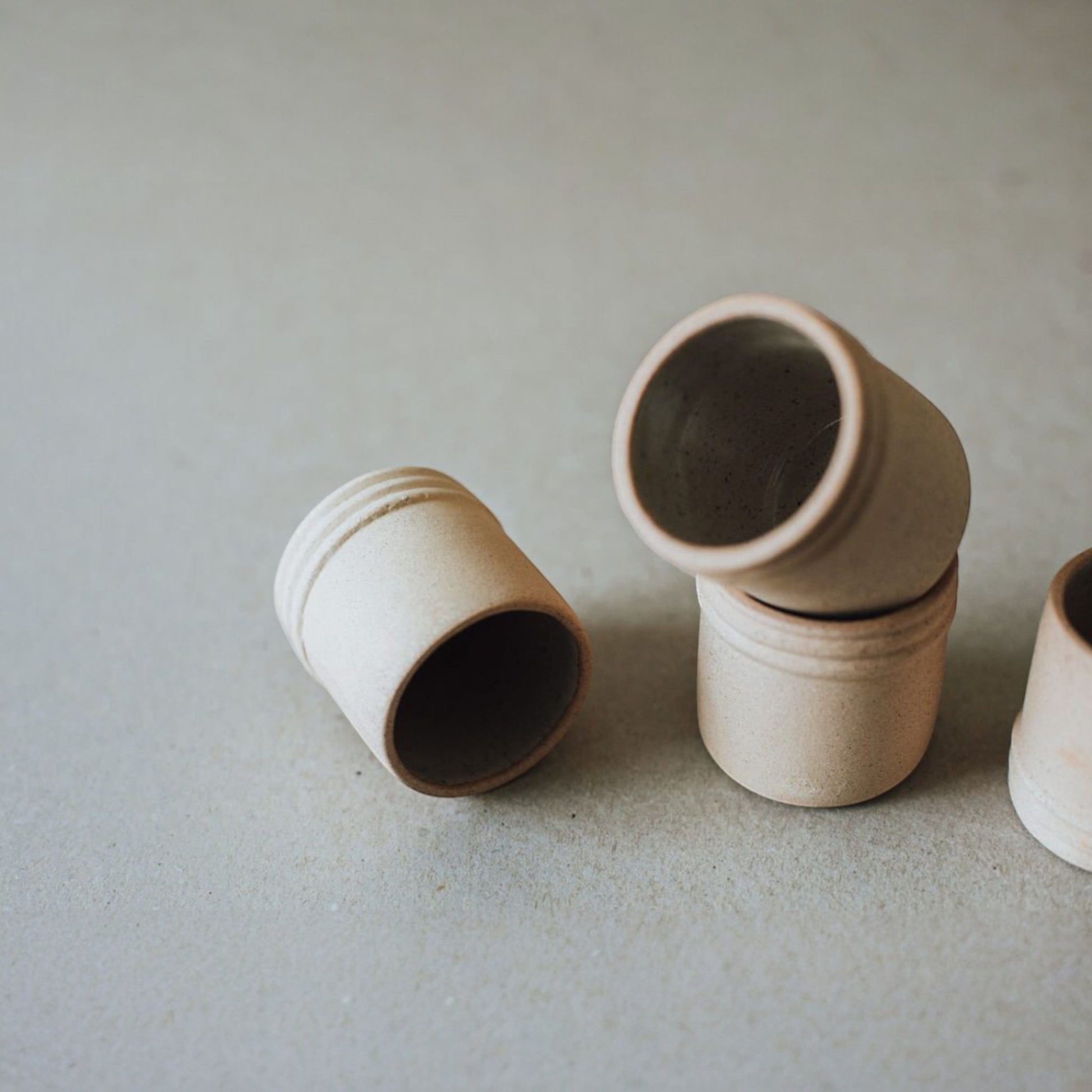 Close-up of ceramic tequila and mezcal shot glasses highlighting the matte exterior and glazed interior finish