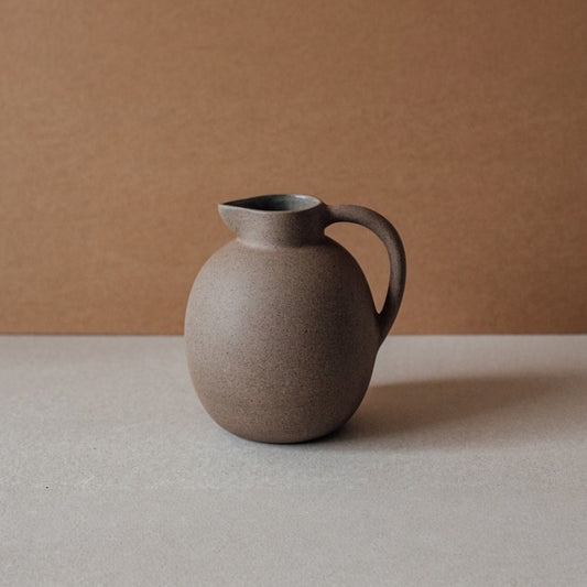 Round terracotta ceramic pitcher with matte finish and sculptural silhouette