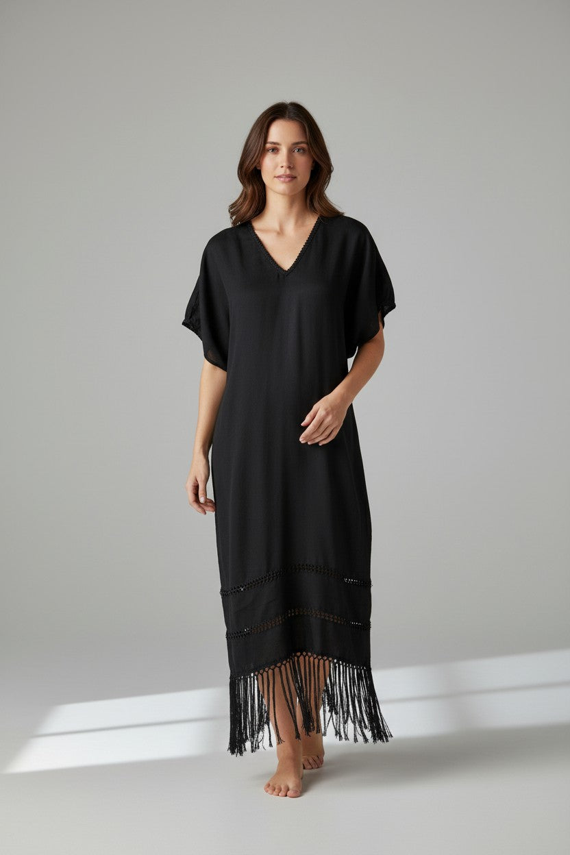 Black silk blend kaftan dress with open-weave detailing and hand-knotted fringe, full-length studio shot