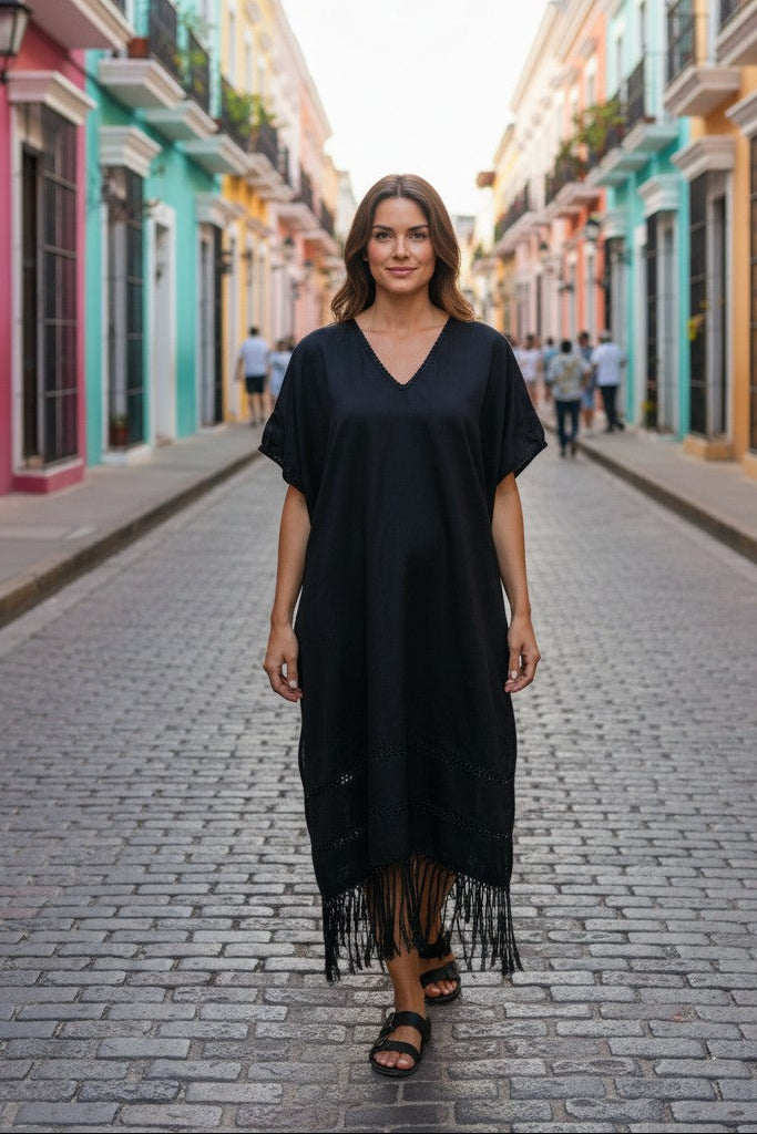 Black silk blend kaftan dress worn walking on a colorful Mexican street, artisan fringe detail