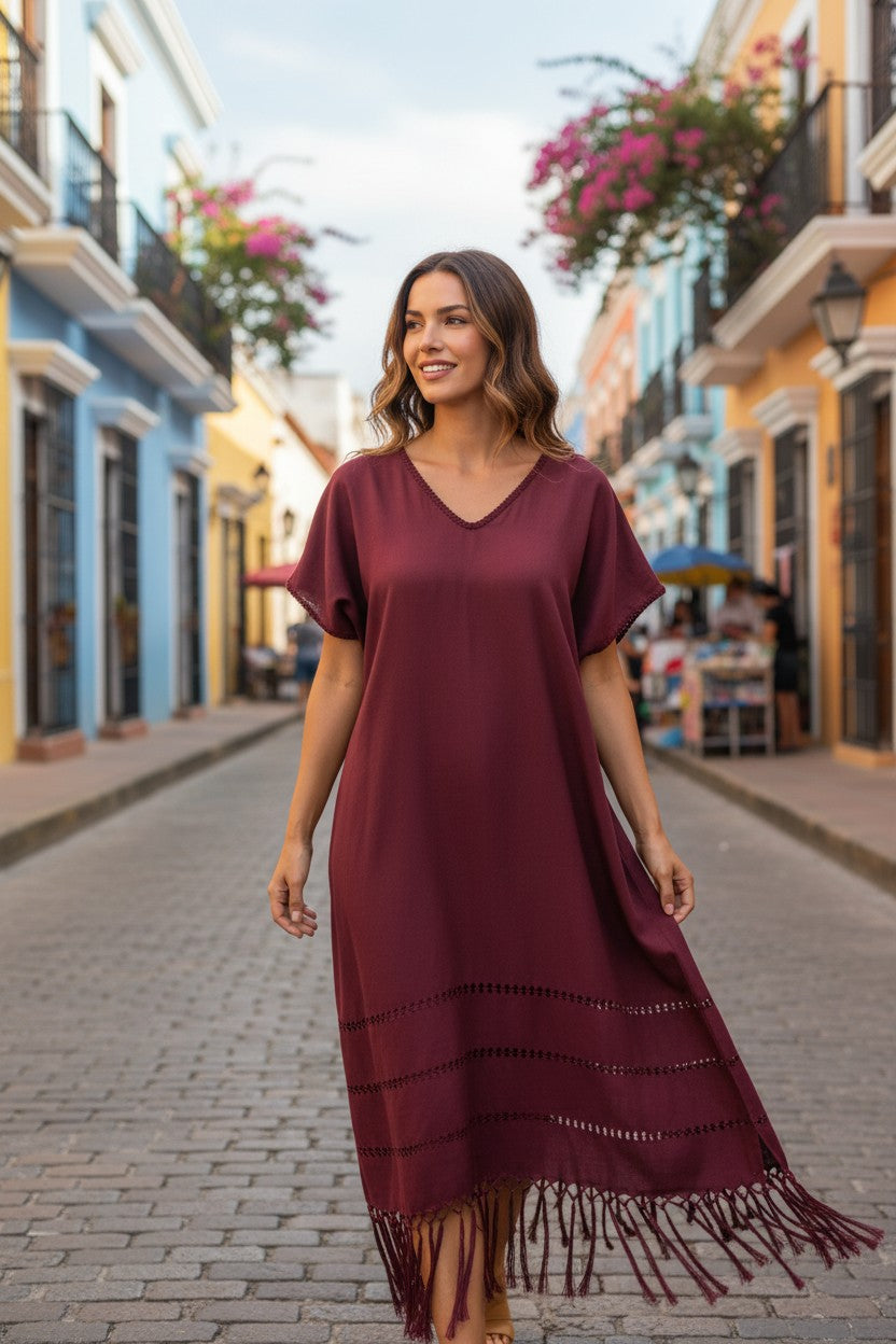 Burgundy handwoven silk blend kaftan dress with open-weave detailing and fringe, lifestyle street photo