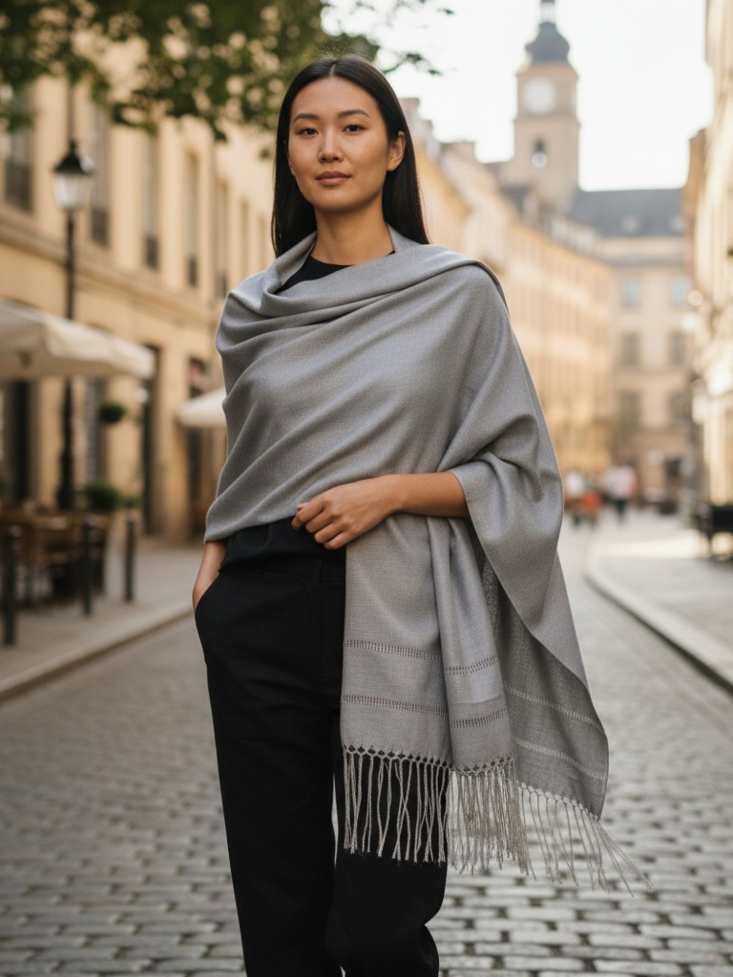 Silver silk-blend rebozo shawl styled as an elegant wrap on city street