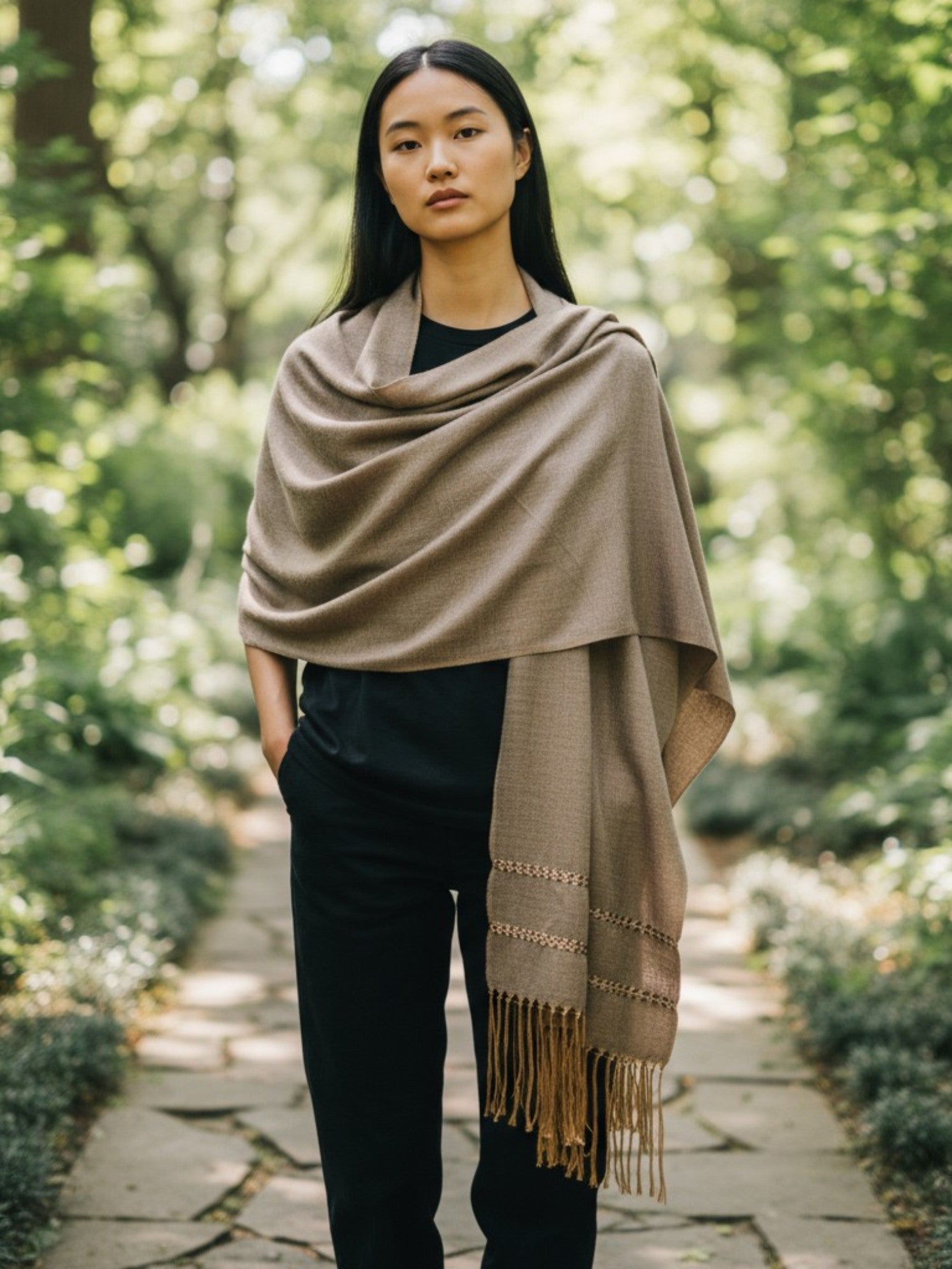 Taupe handwoven silk-blend rebozo shawl worn in a garden setting