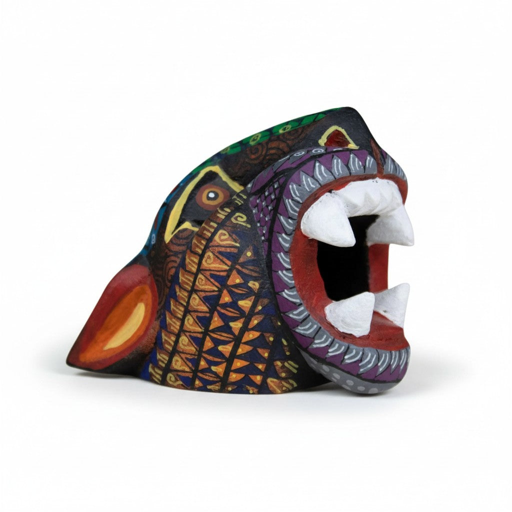 Hand-carved copal wood jaguar alebrije with colorful Oaxacan patterns