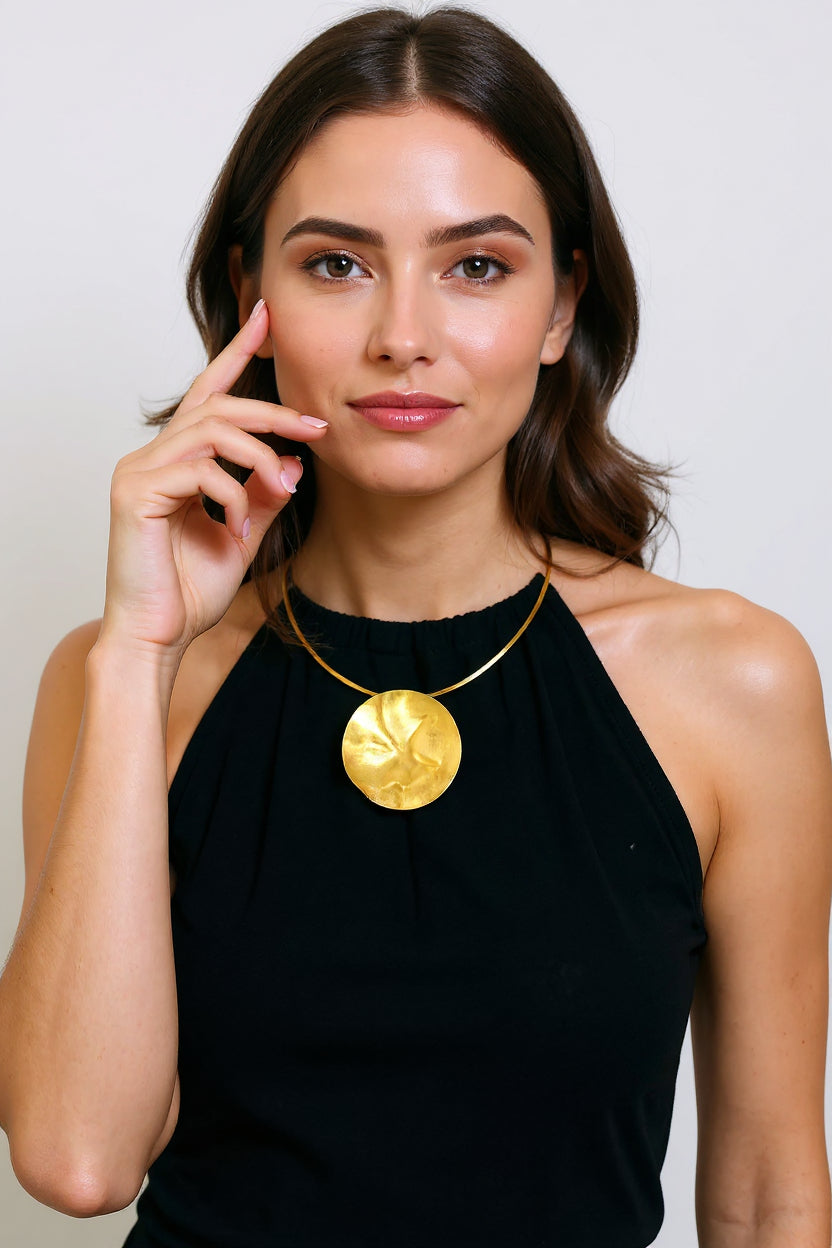 Gold hammered moon pendant choker worn on model, black top