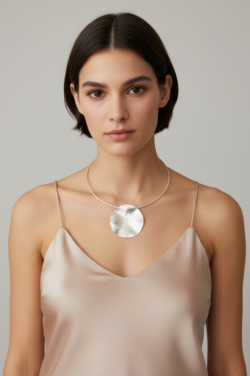 Silver hammered moon pendant choker worn on model, front view