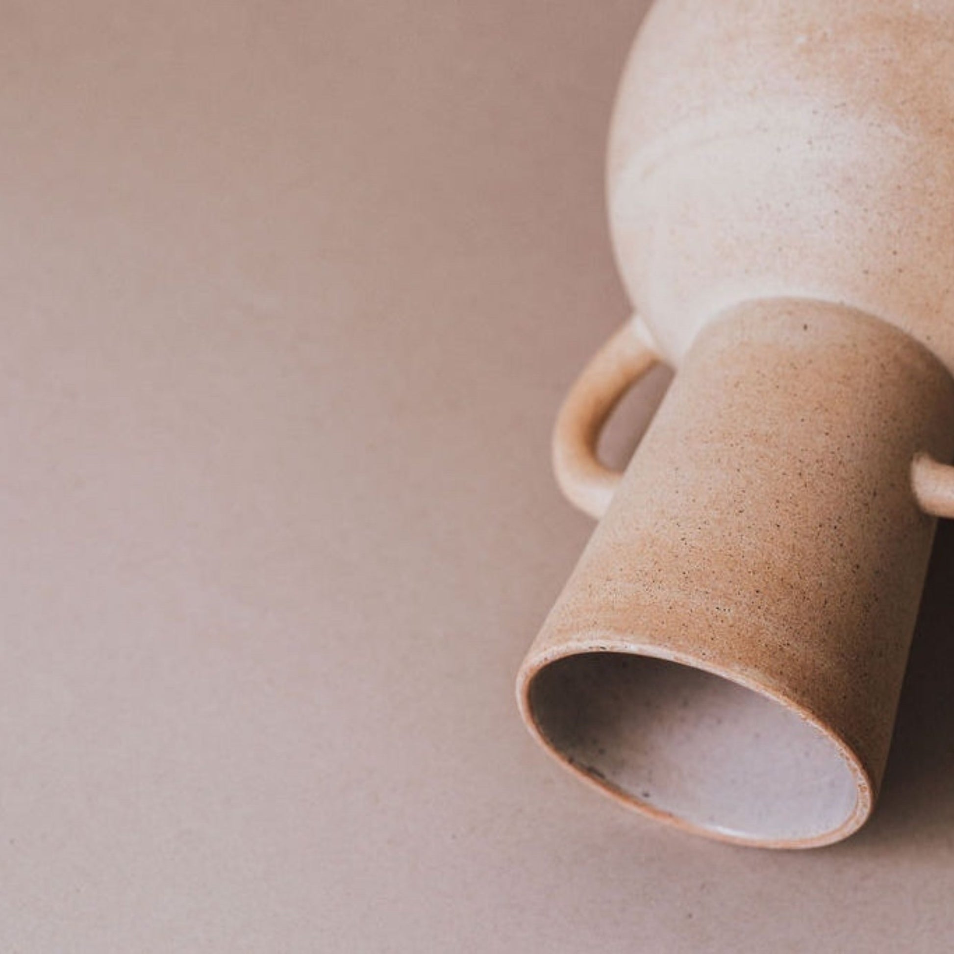 Close up of natural sand ceramic vase showing matte texture