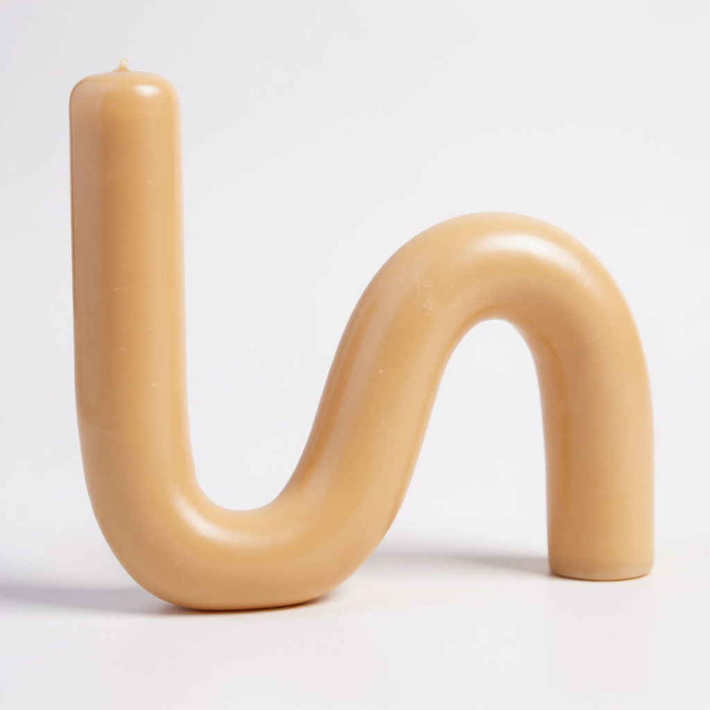 Close-up of a single S-shaped beeswax candle in natural honey color