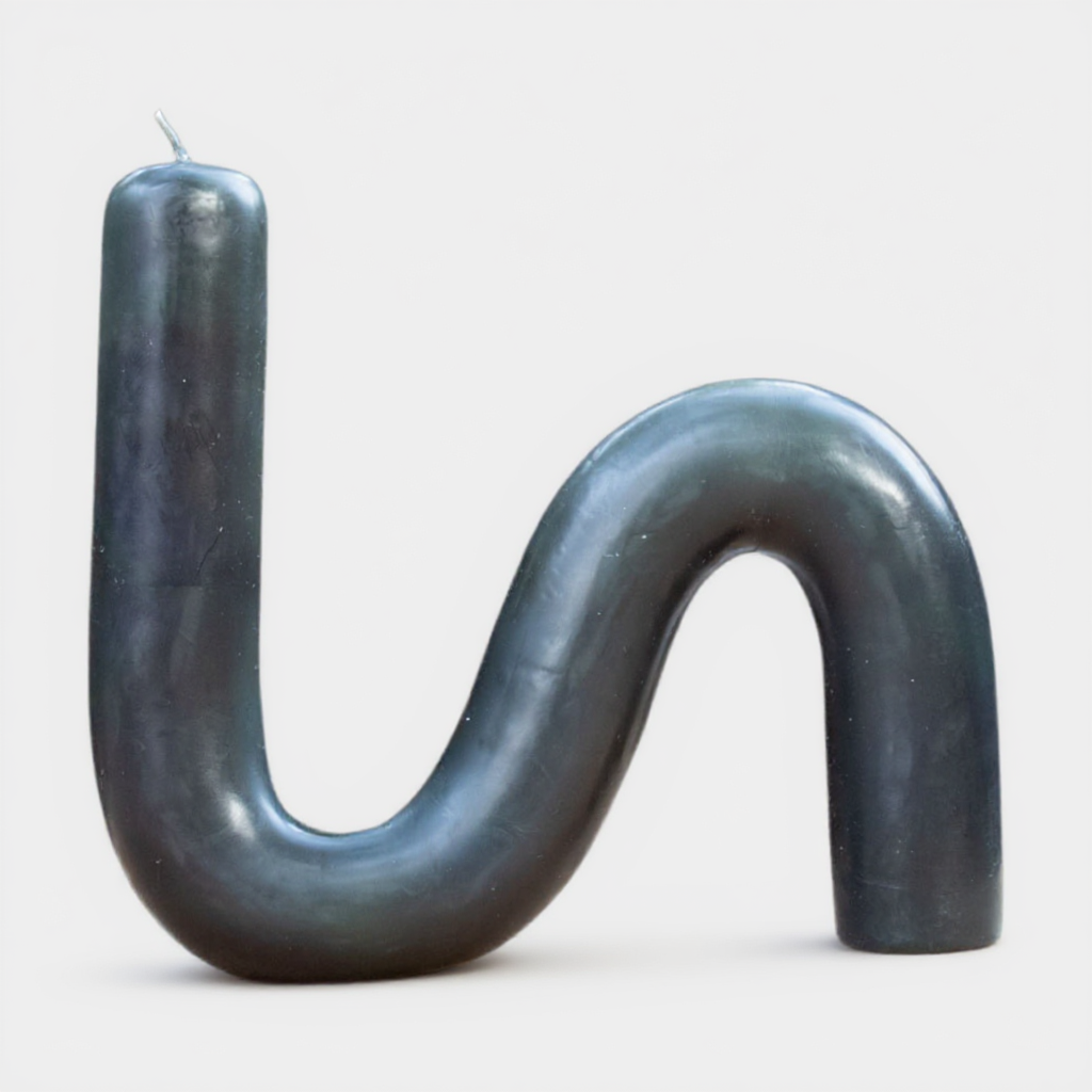 Close-up of a single S-shaped beeswax candle in natural forest green color