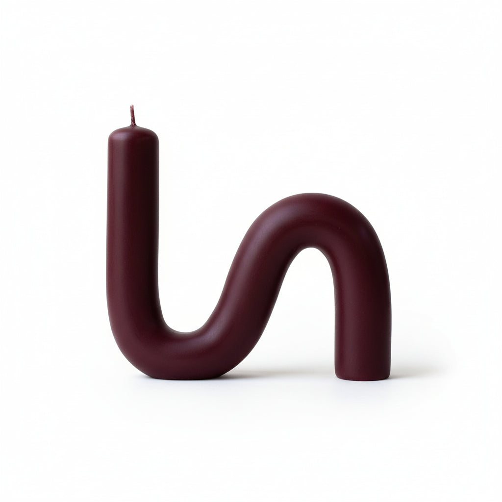 S-shaped beeswax candle in burgundy color on a white background