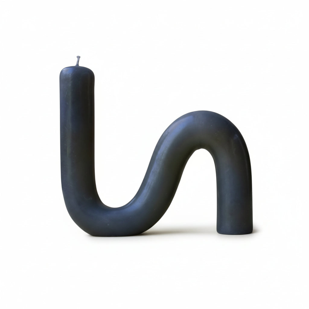 S-shaped beeswax candle in moos green color on a white background 