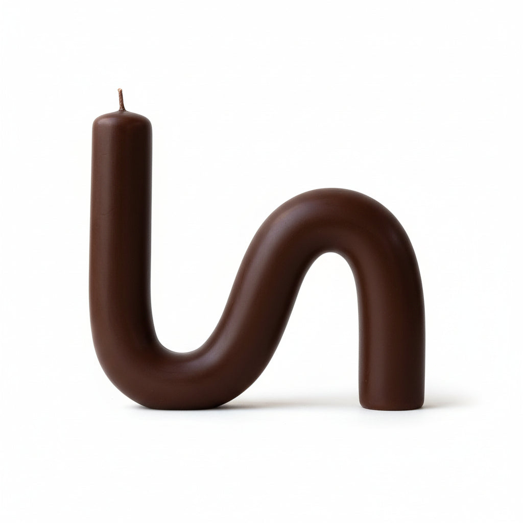 S-shaped beeswax candle in dark brown color on a white background