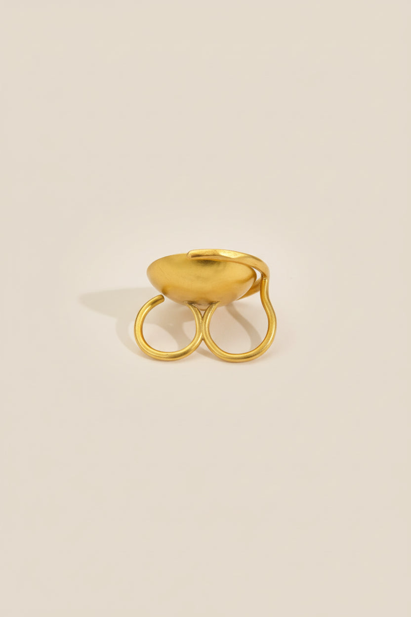 Gold sculptural bowl adjustable ring side view, clean studio background