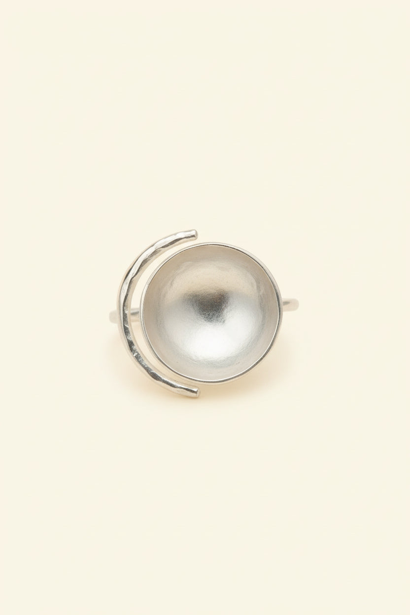 Silver sculptural bowl statement ring photographed alone, light ivory background