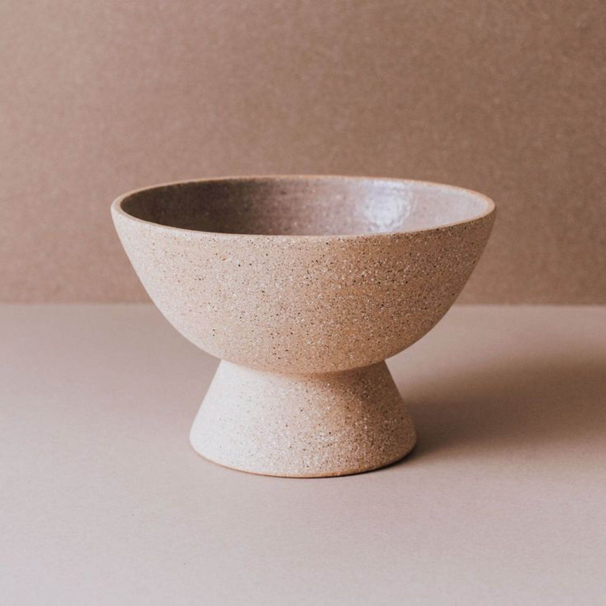 Empty terracotta pedestal bowl, handcrafted ceramic fruit bowl with natural cork finish