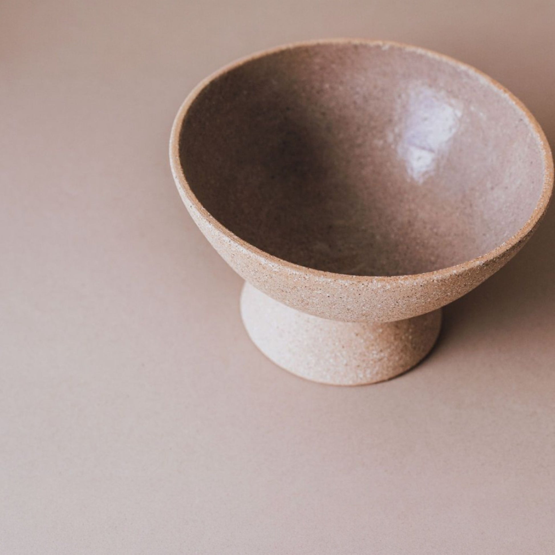 Top view of glazed interior of terracotta pedestal bowl, handcrafted ceramic fruit bowl