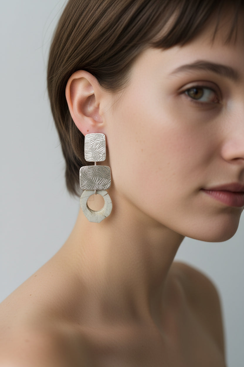 Model wearing silver square deer horn drop earrings, close-up with natural skin texture