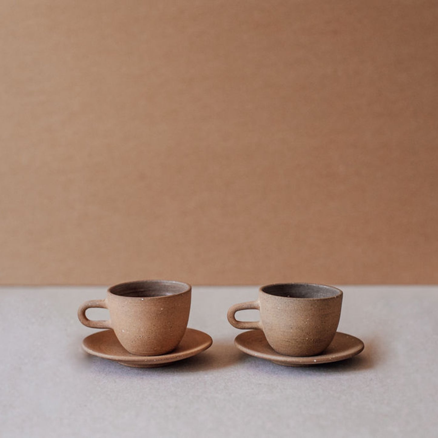Handmade terracotta espresso cups arranged in a row