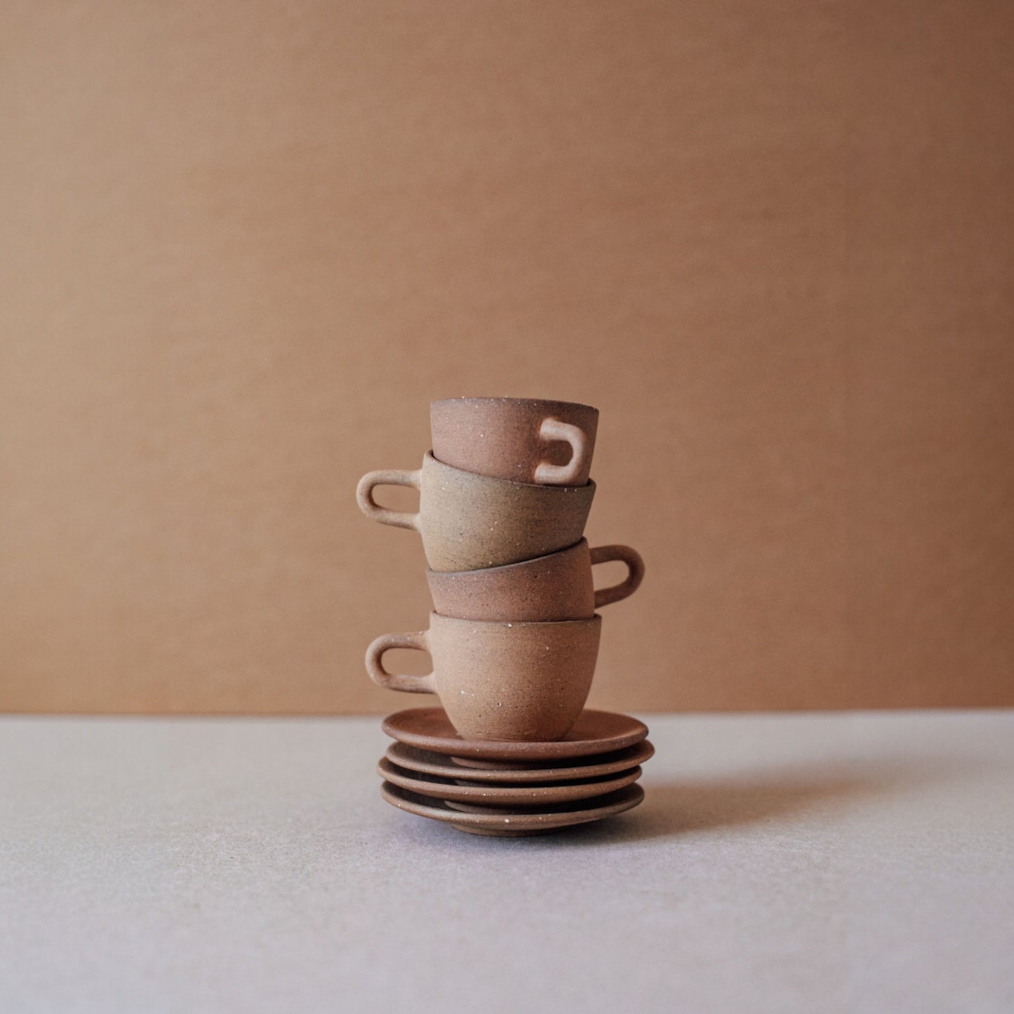 Ceramic espresso cup and saucer stacked vertically