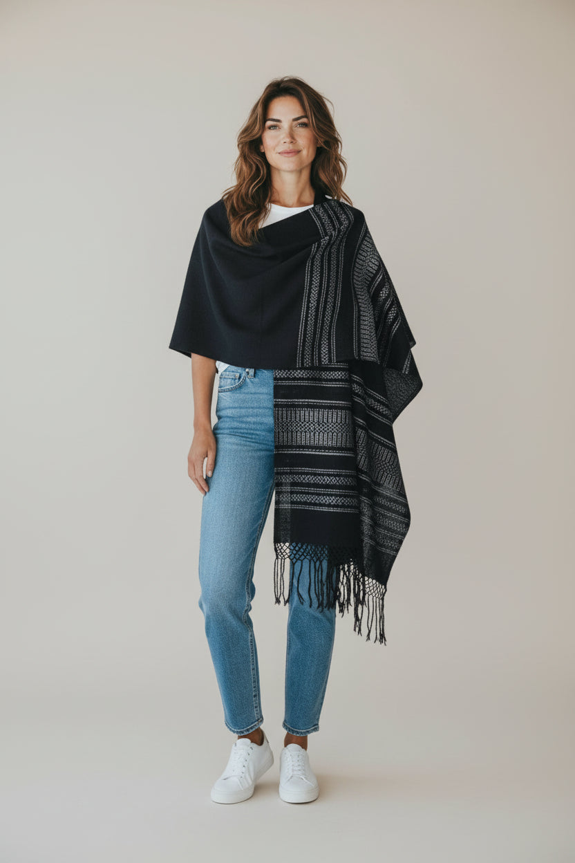 Black handwoven rebozo shawl styled over casual outfit, showing full length and drape