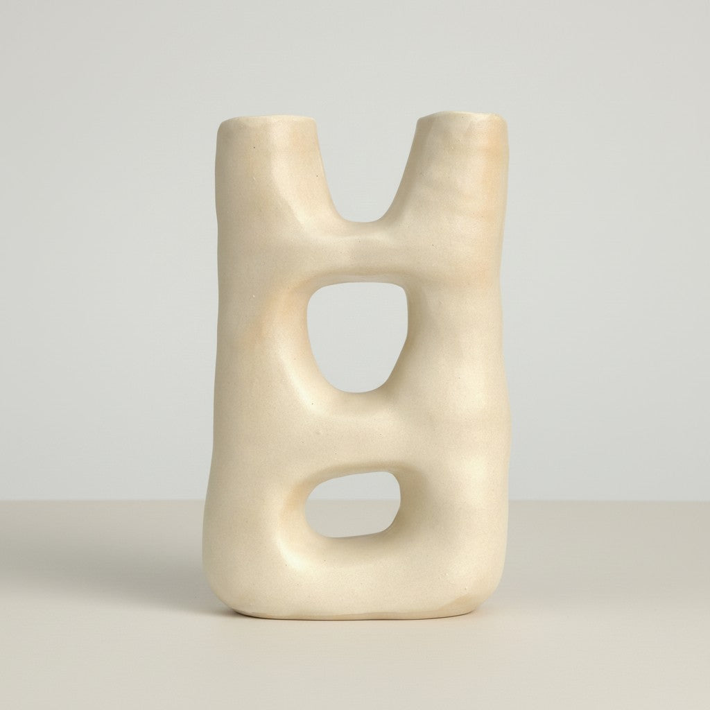 Off-white sculptural ceramic vase with double portal design on a neutral background.
