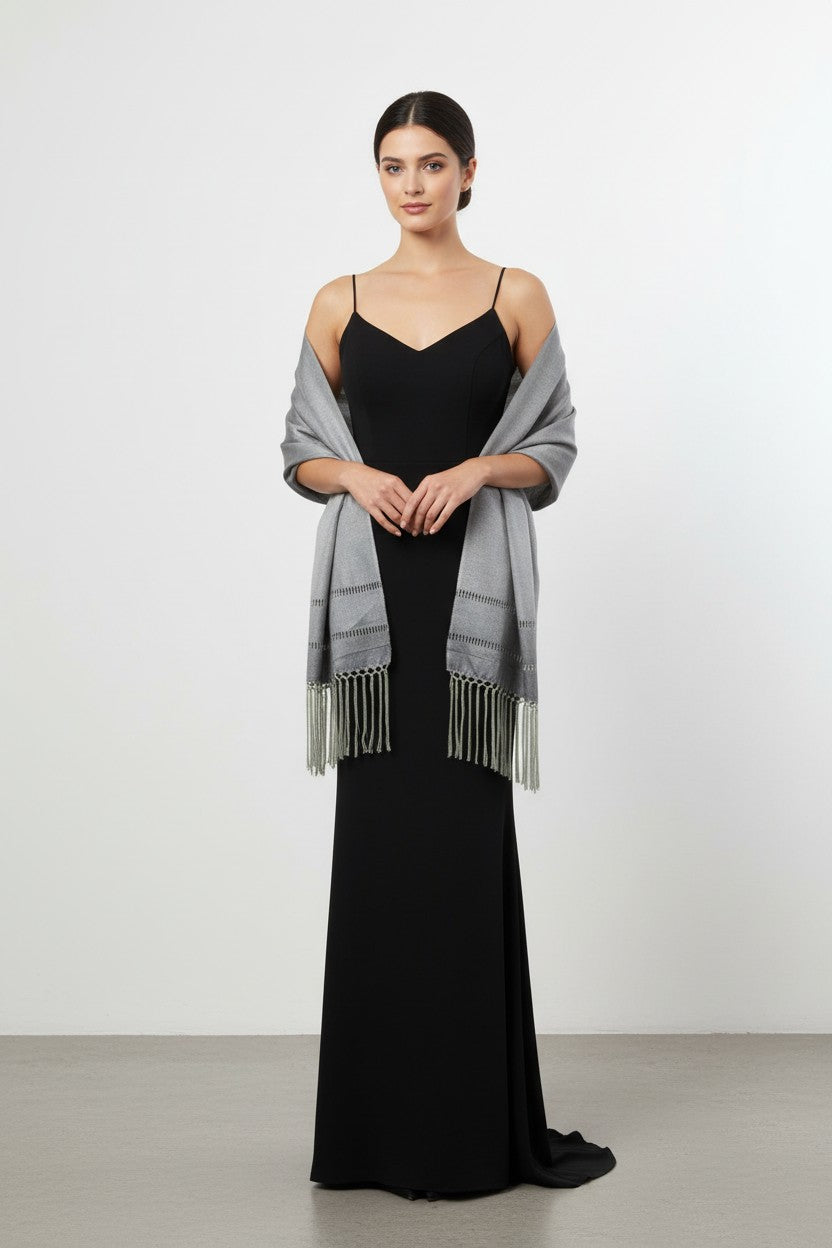 Handwoven gray rebozo shawl with olive green fringe styled over a black evening gown – elegant Mexican artisan wrap for weddings and formal events.