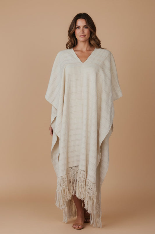 Close-up front view of a model wearing a handwoven cotton kaftan in natural ivory, showing the V-neckline, relaxed drape, and traditional backstrap loom weave texture from Oaxaca, Mexico